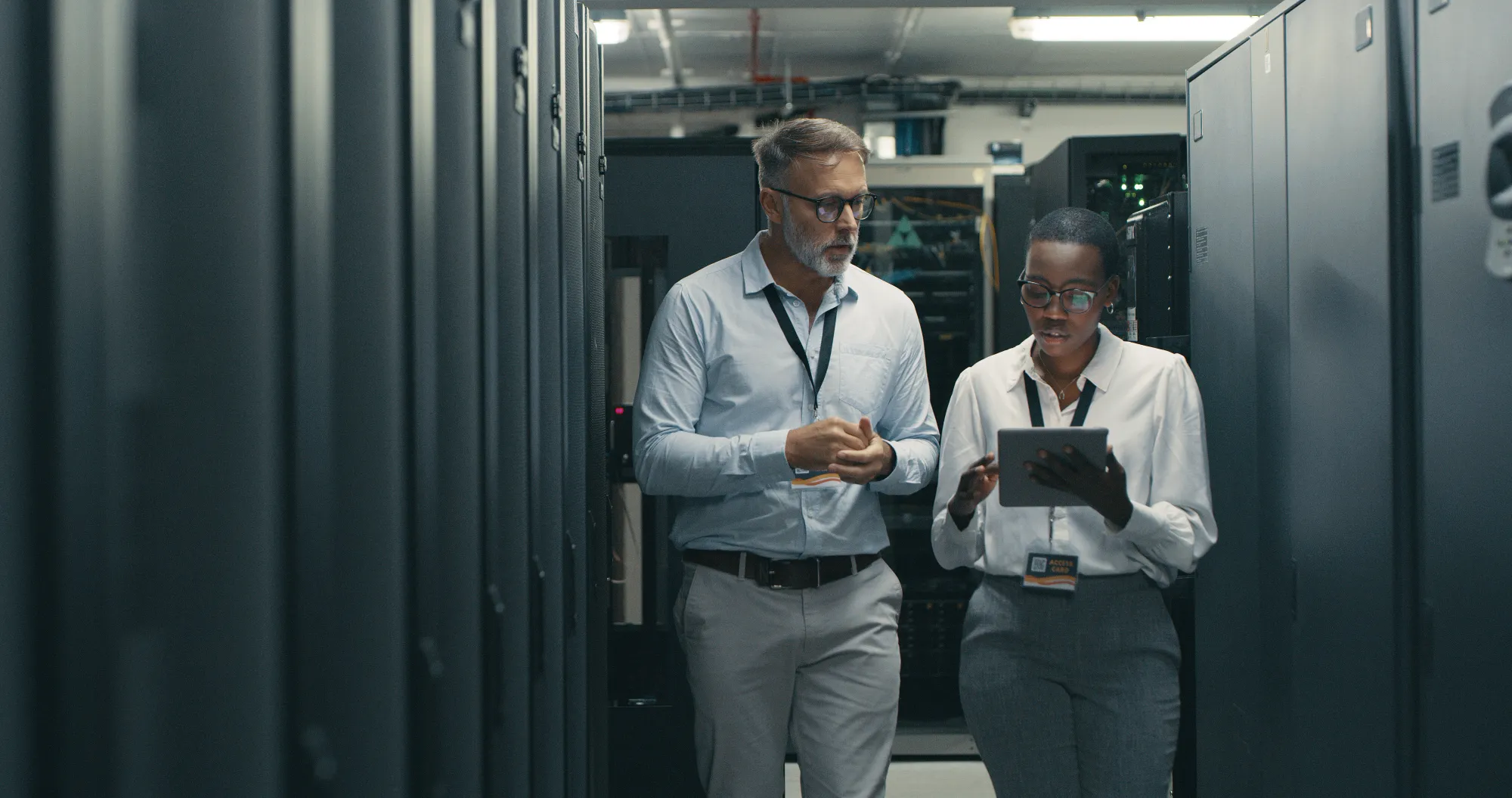 Shot of a man and woman using a digital tablet while working in a data centre