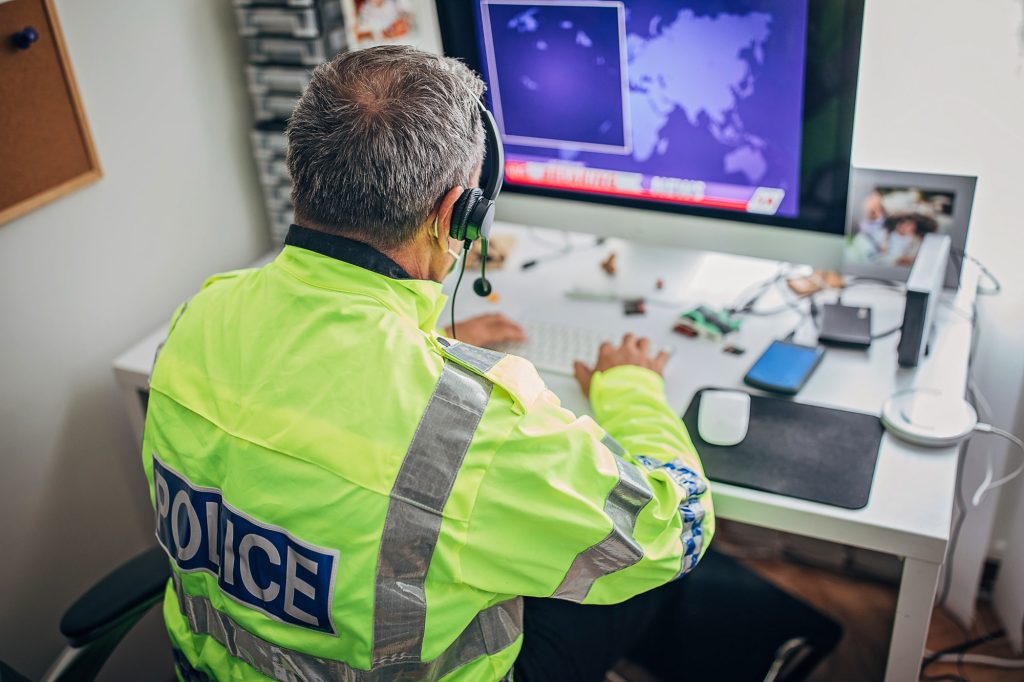One British police officer with protective mask working hard